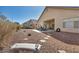 Wide backyard shot with covered patio, providing ample space for relaxation and entertainment at 1484 Midnight Cowboy Ct, Las Vegas, NV 89110