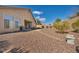 Private backyard featuring desert landscaping, stone patio, and serene setting at 1484 Midnight Cowboy Ct, Las Vegas, NV 89110