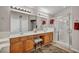 Bright bathroom featuring a glass enclosed shower, double vanity with seating area, and neutral color palette at 1484 Midnight Cowboy Ct, Las Vegas, NV 89110
