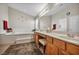 Bright bathroom featuring double sinks, a soaking tub, and a large mirror at 1484 Midnight Cowboy Ct, Las Vegas, NV 89110