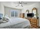 Bedroom featuring a fan, window with white blinds, light gray walls, and dark wooden furniture at 1484 Midnight Cowboy Ct, Las Vegas, NV 89110