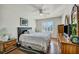 Bedroom with natural light, ceiling fan, window with white blinds and wooden furniture at 1484 Midnight Cowboy Ct, Las Vegas, NV 89110