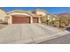 Expansive driveway and three car garage enhance the exterior of this home at 1484 Midnight Cowboy Ct, Las Vegas, NV 89110