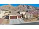 Stunning single-story home boasting a three-car garage and beautifully landscaped front yard with mountain views at 1484 Midnight Cowboy Ct, Las Vegas, NV 89110