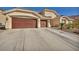 Expansive driveway and three car garage enhance the exterior of this home at 1484 Midnight Cowboy Ct, Las Vegas, NV 89110