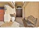 Inviting home entrance with elegant double doors, a decorative bench, and a stylish potted plant at 1484 Midnight Cowboy Ct, Las Vegas, NV 89110