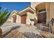 Inviting entrance to home with desert landscaping, seating bench and statement double doors at 1484 Midnight Cowboy Ct, Las Vegas, NV 89110