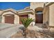 Charming front entrance features a double door, a cozy bench, and a well-manicured yard at 1484 Midnight Cowboy Ct, Las Vegas, NV 89110