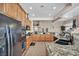 A wide shot of the kitchen featuring a spacious granite countertop island and open view of the dining and living area at 1484 Midnight Cowboy Ct, Las Vegas, NV 89110