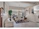 Bright living room with plush white sofas, stylish décor, and an abundance of natural light at 1484 Midnight Cowboy Ct, Las Vegas, NV 89110