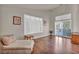 Bright and airy living room with hardwood floors, plantation shutters, and sliding glass doors at 1484 Midnight Cowboy Ct, Las Vegas, NV 89110