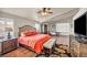 Spacious main bedroom with hardwood floors, ceiling fan, plantation shutters and ensuite seating area at 1484 Midnight Cowboy Ct, Las Vegas, NV 89110