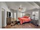 Spacious main bedroom featuring hardwood floors, ceiling fan, plantation shutters and ensuite seating area at 1484 Midnight Cowboy Ct, Las Vegas, NV 89110