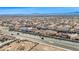 Wide aerial perspective of a desert community nestled near city and mountains at 1484 Midnight Cowboy Ct, Las Vegas, NV 89110