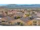 Aerial view of a vibrant residential neighborhood with city skyline at 1484 Midnight Cowboy Ct, Las Vegas, NV 89110