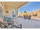 Large covered patio with comfortable seating and a view of the landscaped backyard at 1484 Midnight Cowboy Ct, Las Vegas, NV 89110