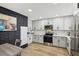 Well-appointed kitchen featuring white cabinets, stainless steel appliances, and ample counter space at 184 Greenbriar Townhouse Way, Las Vegas, NV 89121