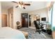 Bedroom featuring a TV, a large closet, comfortable seating, and a computer desk, creating a functional retreat at 2115 Saint Paul Way, Las Vegas, NV 89104