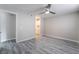 Bedroom with wood floors, ceiling fan, and a view towards the kitchen area at 220 Mission Catalina Ln # 202, Las Vegas, NV 89107