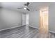 Bedroom showcasing wood floors, closet, ceiling fan, and bright en-suite bathroom at 220 Mission Catalina Ln # 202, Las Vegas, NV 89107