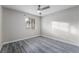 Neutral bedroom with modern ceiling fan, window and gray wood-look flooring at 220 Mission Catalina Ln # 202, Las Vegas, NV 89107