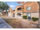 Exterior shot of building with orange stucco, landscaping, and mature trees at 220 Mission Catalina Ln # 202, Las Vegas, NV 89107