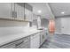 Modern kitchen with gray cabinets, white countertops, and stainless steel sink and appliances at 220 Mission Catalina Ln # 202, Las Vegas, NV 89107