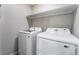 Bright laundry room with a modern washer and dryer and ample shelf space at 220 Mission Catalina Ln # 202, Las Vegas, NV 89107