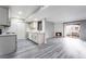 Open floor plan featuring modern kitchen, wood-look laminate flooring and views to the balcony at 220 Mission Catalina Ln # 202, Las Vegas, NV 89107