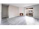 Light and bright living room with fireplace, wood-look laminate flooring, and sliding door access to the balcony at 220 Mission Catalina Ln # 202, Las Vegas, NV 89107