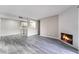 Open floor plan featuring modern kitchen, fireplace, and wood-look laminate flooring at 220 Mission Catalina Ln # 202, Las Vegas, NV 89107