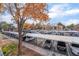 Elevated view of an expansive parking lot with carport covers and mature trees at 220 Mission Catalina Ln # 202, Las Vegas, NV 89107