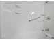 Bright white shower-tub combo featuring built-in shelving and grab bar at 220 Mission Catalina Ln # 202, Las Vegas, NV 89107