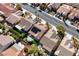 Aerial view of a home with solar panels, a covered patio, and a well-maintained lawn at 2210 Shadow Canyon Dr, Henderson, NV 89044