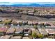 Scenic aerial view of a desert neighborhood showcasing mountain views and tile roofs at 2210 Shadow Canyon Dr, Henderson, NV 89044