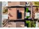 Aerial view of a landscaped backyard with artificial turf, patio cover, and solar panels at 2210 Shadow Canyon Dr, Henderson, NV 89044