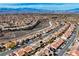 Expansive aerial view showcasing a well-planned community, mountain views and winding roads at 2210 Shadow Canyon Dr, Henderson, NV 89044