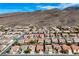 Aerial view of a residential community with mountain backdrop and desert landscaping at 2210 Shadow Canyon Dr, Henderson, NV 89044