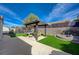 Relaxing backyard features a shaded pergola, outdoor seating and lush synthetic grass for low-maintenance enjoyment at 2210 Shadow Canyon Dr, Henderson, NV 89044