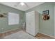 This bright bedroom features wood-look floors, a ceiling fan, and a unique storage cabinet at 2210 Shadow Canyon Dr, Henderson, NV 89044