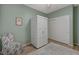 This bedroom features wood-look floors, a storage cabinet, and a large double door closet at 2210 Shadow Canyon Dr, Henderson, NV 89044