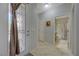 Welcoming entryway with decorative glass door, tiled flooring, and access to a full bathroom nearby at 2210 Shadow Canyon Dr, Henderson, NV 89044