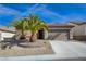 Charming single-story home boasts desert landscaping, a two-car garage, and a welcoming entrance at 2210 Shadow Canyon Dr, Henderson, NV 89044
