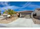 Charming single-story home featuring a well-manicured lawn and a two-car garage with decorative accents at 2210 Shadow Canyon Dr, Henderson, NV 89044