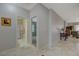 Hallway leading to the bathroom and bedroom, featuring neutral walls and tile flooring throughout at 2210 Shadow Canyon Dr, Henderson, NV 89044