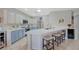 Modern kitchen boasts stainless steel appliances, quartz countertops, and seating at the breakfast bar at 2210 Shadow Canyon Dr, Henderson, NV 89044