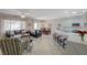 Bright living space with a tile floor, plush seating, and seamless flow to the kitchen and dining areas at 2210 Shadow Canyon Dr, Henderson, NV 89044