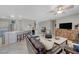 Open concept living room adjacent to kitchen featuring tile floors and a comfortable seating area at 2210 Shadow Canyon Dr, Henderson, NV 89044