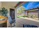 Inviting patio area featuring synthetic grass, comfortable seating, and a charming pergola for outdoor enjoyment at 2210 Shadow Canyon Dr, Henderson, NV 89044