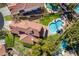 An aerial view shows the sparkling pool, spa, lush backyard, and tile roof at 229 Drysdale Cir, Henderson, NV 89074